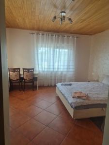 a bedroom with a bed and a table and chairs at Gintolina in Kazlų Rūda +10 photos