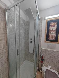 a shower with a glass door in a bathroom at Villa Shiva Cerveteri, Casa Vacanze con SPA e Idromassaggio, Relax a due passi da Roma in Cerveteri +36 photos