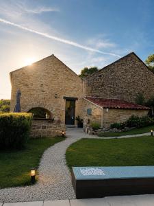 a stone building with a pathway leading to a door at Larroque Haute Gites in Cassagnes