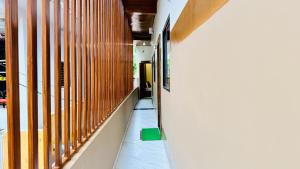 a corridor of a building with wooden walls and a green floor at Hotel Gurukripa Palace in Maheshwar +39 photos