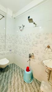 a bathroom with a toilet and a sink at Hotel Gurukripa Palace in Maheshwar