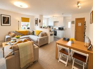 a living room with a couch and a table at Muddy Boots Scarpa in Kirkby Stephen