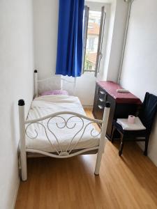 a small bedroom with a bed and a desk at Private Room Pré-Saint-Gervais in Le Pré-Saint-Gervais +13 photos