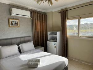 a bedroom with a large bed and a window at Gem View Grand Boutique in Cairo +50 photos