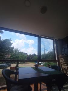 a dining room with a table and a large window at Sunset Otel in Şile