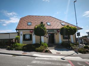 a small house with a red roof on a street at Beli oblaki in Gradišče v Slovenskih Goricah +2 photos