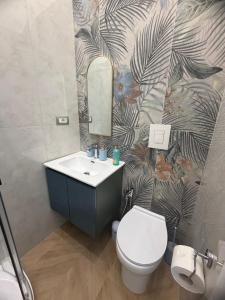 a bathroom with a toilet and a sink and a mirror at DOMUS LUIGI LEONE 2 in Naples +101 photos
