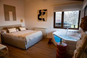 a bedroom with a bed and a bath tub at Casas del Tremedal in Tremedal +109 photos