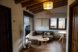 a living room with a couch and a table at Casas del Tremedal in Tremedal