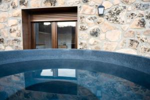 a stone house with a pool in front of a building at Casas del Tremedal in Tremedal