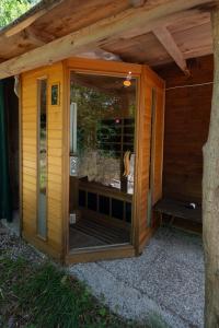 a wooden sauna with a large glass door at 349 - Bosco Selvaggio con piscina, Palestra, Sport & Wellness - PARCHEGGIO GRATUITO INCLUSO in Reppia