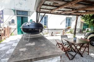 a grill sitting on a table on a patio at 349 - Bosco Selvaggio con piscina, Palestra, Sport & Wellness - PARCHEGGIO GRATUITO INCLUSO in Reppia