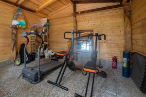 a gym with two exercise bikes in a room at 349 - Bosco Selvaggio con piscina, Palestra, Sport & Wellness - PARCHEGGIO GRATUITO INCLUSO in Reppia