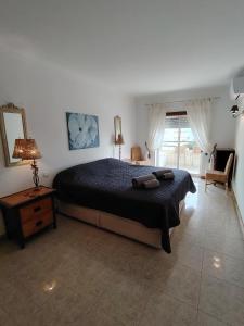 a bedroom with a large bed and a window at T2 Galé Mar Retreat - Beach in Galé