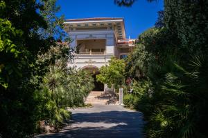 a large white building with a stairway leading to it at Ali Bey Resort Sorgun in Side