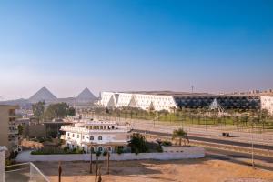 a view of a building with pyramids in the background at Gem View Grand Boutique in Cairo