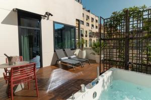 a hot tub on a balcony with a table and chairs at Negresco Princess 4* Sup in Barcelona