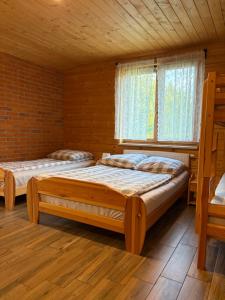 a bedroom with two beds and a window at Agroturystyka Rumcajsówka in Bałtów