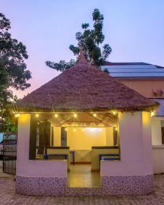 a gazebo with a roof with lights on it at Navy Guest House, Kaduna in Kaduna