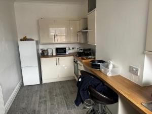 a small kitchen with a counter and a refrigerator at Montagu Street in Kettering