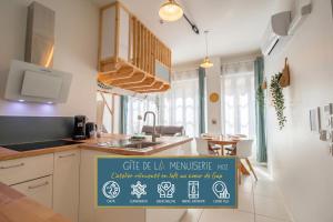 a kitchen with a sign for a new house at Gîte de La Menuiserie in Gap