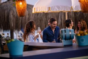 a group of people sitting at a table with wine glasses at Ali Bey Resort Sorgun in Side +149 photos