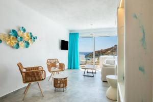 a living room with a view of the ocean at Poseidon Blue Gastronomy Hotel in Afiartis