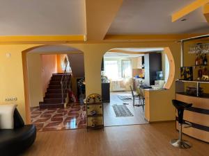 a living room with a staircase and a kitchen and a living room at Vila Nana in Râmnicu Vâlcea