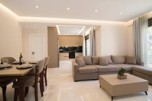 a living room with a couch and a table at Glamour Residences 3-4 by CorfuEscapes in Análipsis
