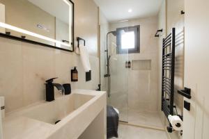 a bathroom with a sink and a shower at Glamour Residences 3-4 by CorfuEscapes in Análipsis +11 photos