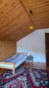a bedroom with a bed and a wooden ceiling at Holiday Home Nana in Bugojno