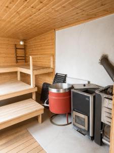 a small kitchen with a stove in a room at Villa Ralli in Jämsä +1 photo