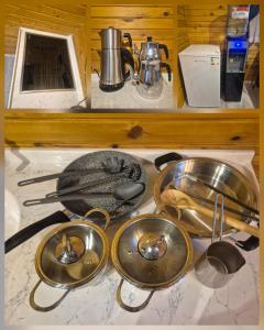 a group of kitchen utensils and pans on a counter at Yonga Bungalov in Akcaabat +10 photos