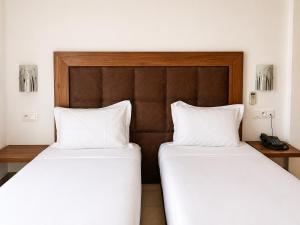 two beds sitting next to each other in a room at Hotel Etoile Du Nord in Tangier