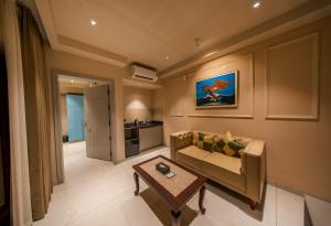 a living room with a couch and a table at Hanric by Eight Continents Amaranta, Varkala in Varkala