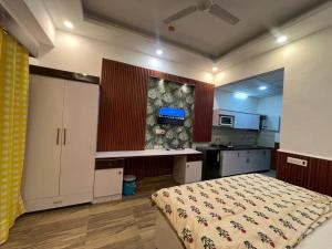 a large bedroom with a bed and a kitchen at GRiK STAY in Greater Noida