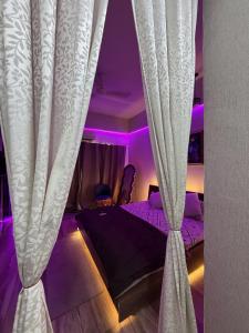 a bedroom with a bed with a curtain at GRiK STAY in Greater Noida
