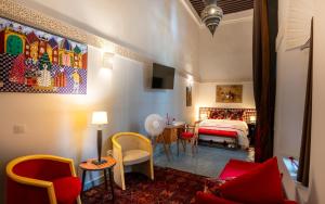 a bedroom with a bed and a table and chairs at Dar Lalzohra in Rabat +191 photos
