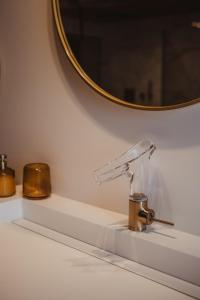 a bathroom counter with a sink with a mirror at L'exclusif douceur in Aubel +22 photos