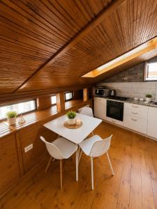 a kitchen with a table and chairs in a room at AFY STAYS Boutique Apartments in Bucharest