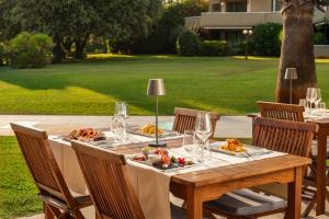 a wooden table with plates of food on it at Hotel Villa Undulna - Terme della Versilia in Cinquale
