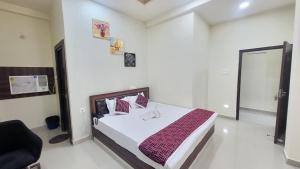 a bedroom with a bed in a room at Hotel Adarsh in Khagaul +8 photos