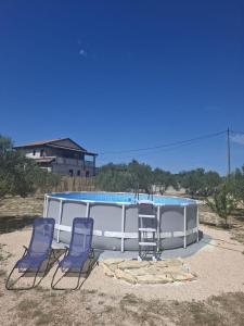 a group of three chairs and a swimming pool at Camp Oblica - parcela - empty plot in Pirovac