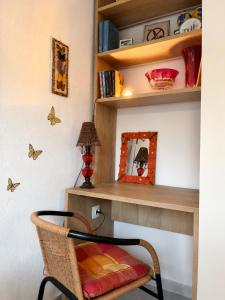 a chair in a room with a shelf and a mirror at Pefkostalia in Pefkochori