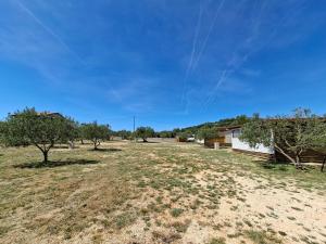 an open field with trees and a building at Camp Oblica - parcela - empty plot in Pirovac