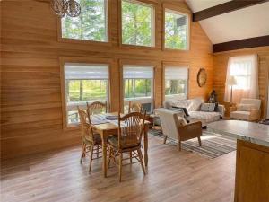 a living room with a table and chairs and a couch at Private Beach Escape - Chalet Ferdinand in Grand Barachois