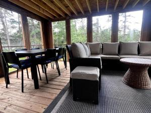 a living room with a couch and a table and chairs at Private Beach Escape - Chalet Ferdinand in Grand Barachois