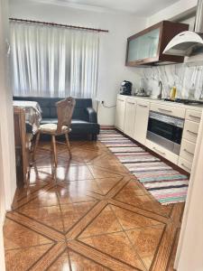 a kitchen with a couch and a table and a chair at Apartament Adelina Borsa in Borşa