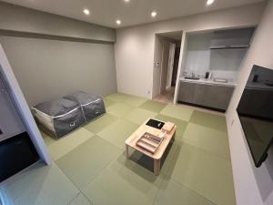 a small room with a table and a kitchen at 乃宿-noyado-博多 in Fukuoka
