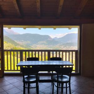 a table and chairs on a balcony with a view at Agritur Maso Carpenè in Rovereto